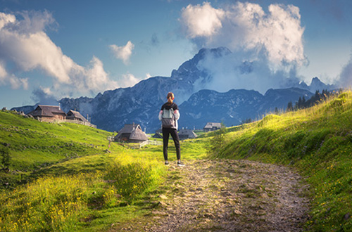 hiker-velika-planina-kamnik-savinja-alps-slovenia-shutterstock2479235051