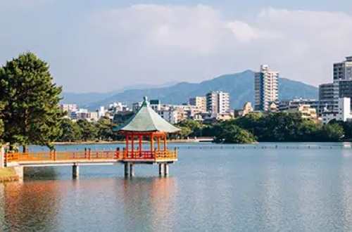 Fukuoka-water-with-buildings-mountains-background-japan