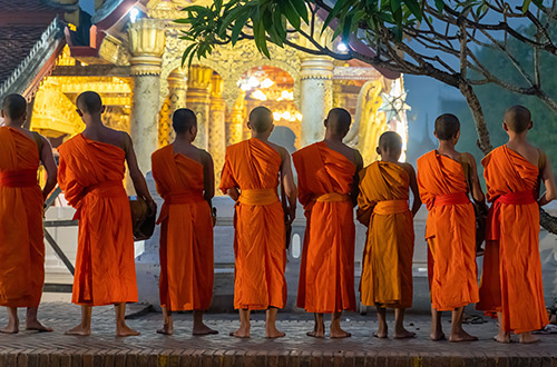 buddhist-monks-begging-for-alms-luang-prabang-laos-shutterstock2189833775