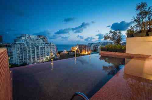 hotel-holms-in-st-julians-pool-dusk