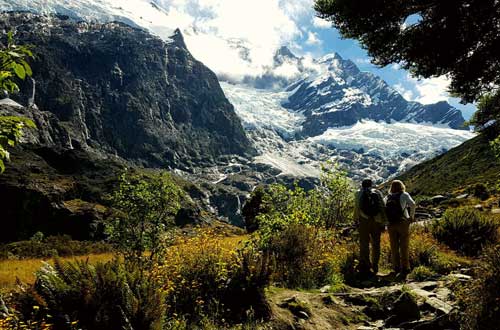 couple-at-valley-head-and-glacier-new-zealand